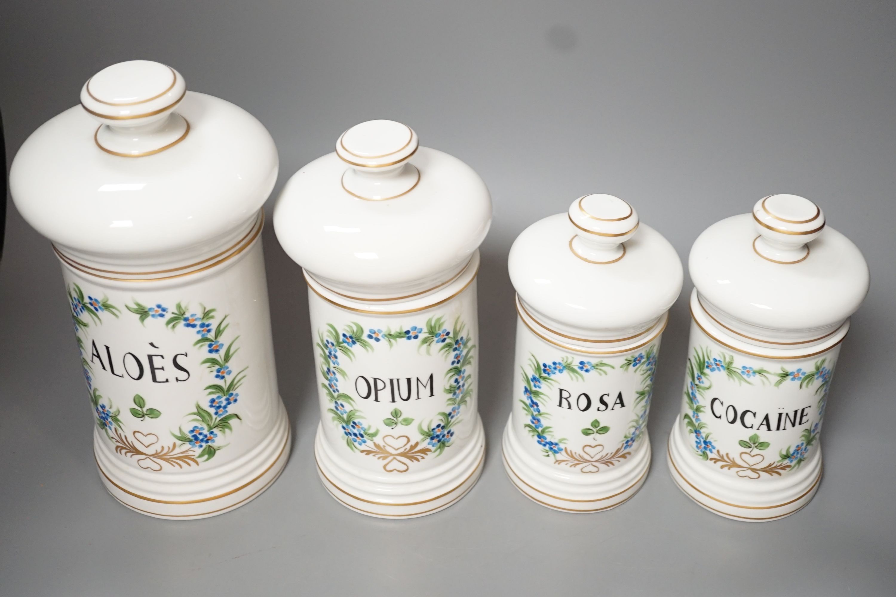 Four graduated porcelain apothecary jars - tallest 26cm